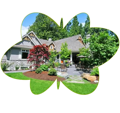 Beautiful home garden landscaping with green lawn, plants, and outdoor seating area.