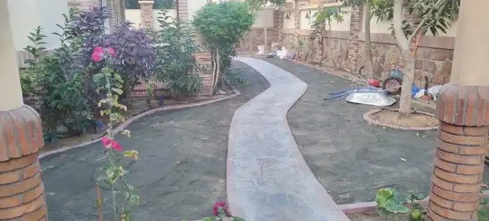Natural stone crazy paving pathway being installed through a Jumeirah villa garden during early-stage landscaping work